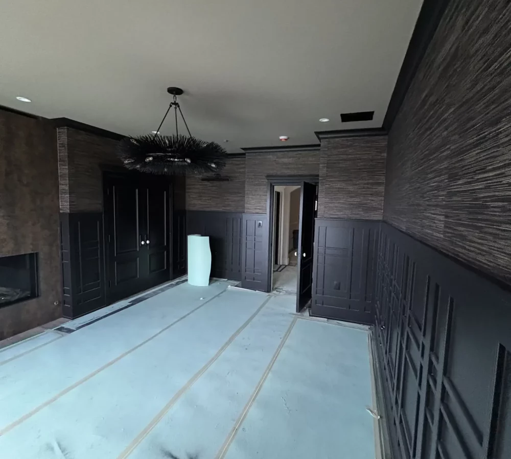 Crew preparing surfaces and applying primer as part of a documented painting process.